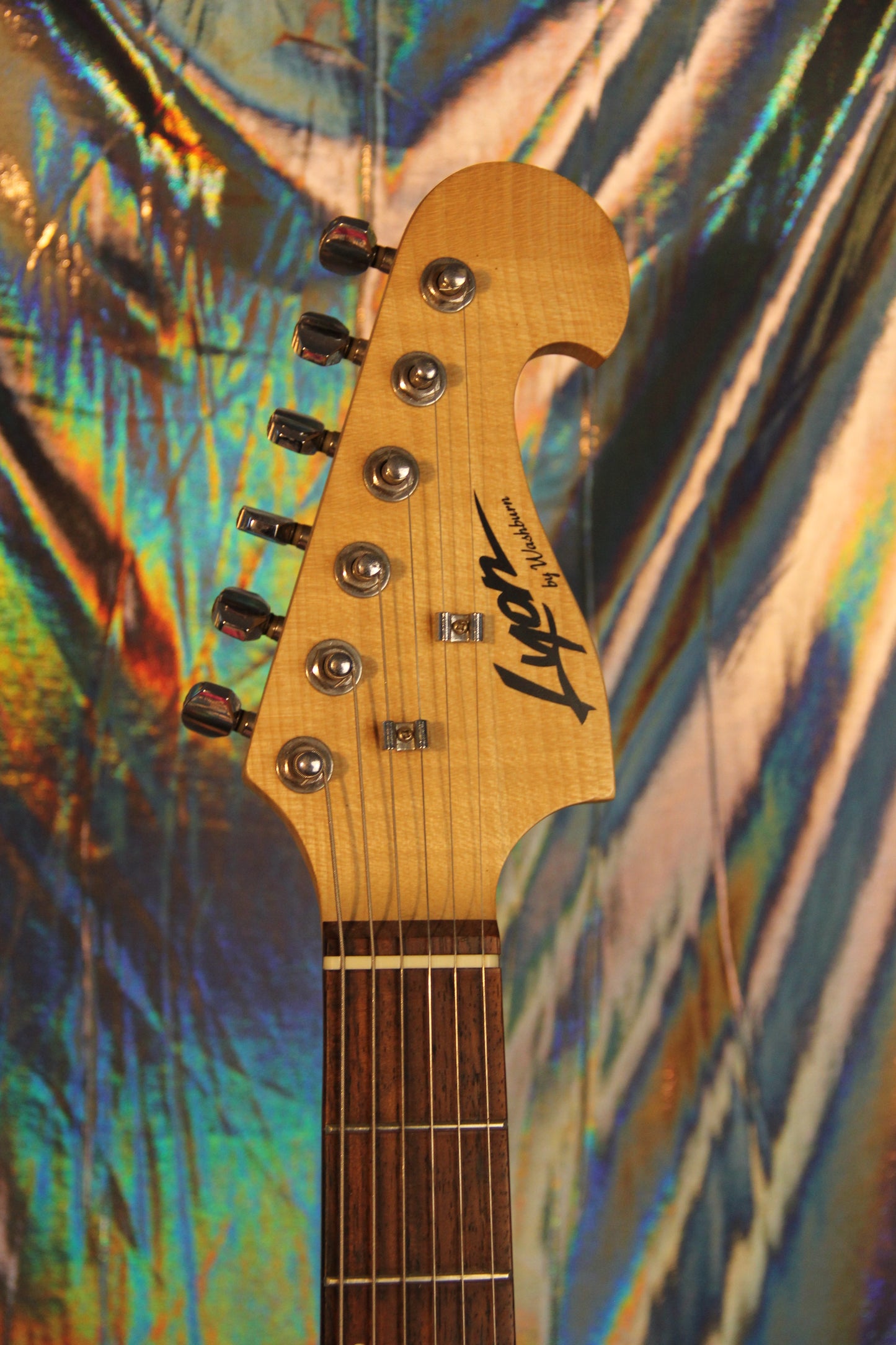 Close up photograph of front headstock of Strat style Lyon Elecrtic Guitar